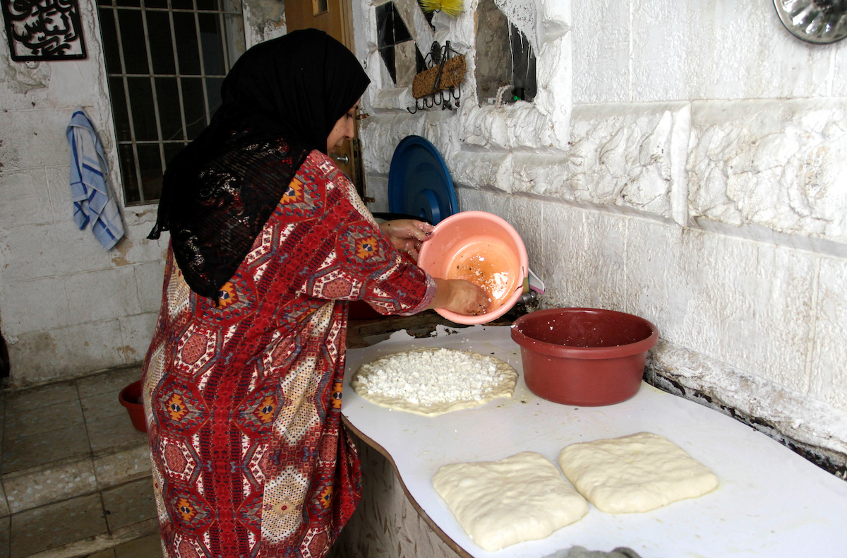 Palestinian woman Rawda Atyani makes pastries with her family at her home in the city of Nablus in the West Bank on September 16 2023