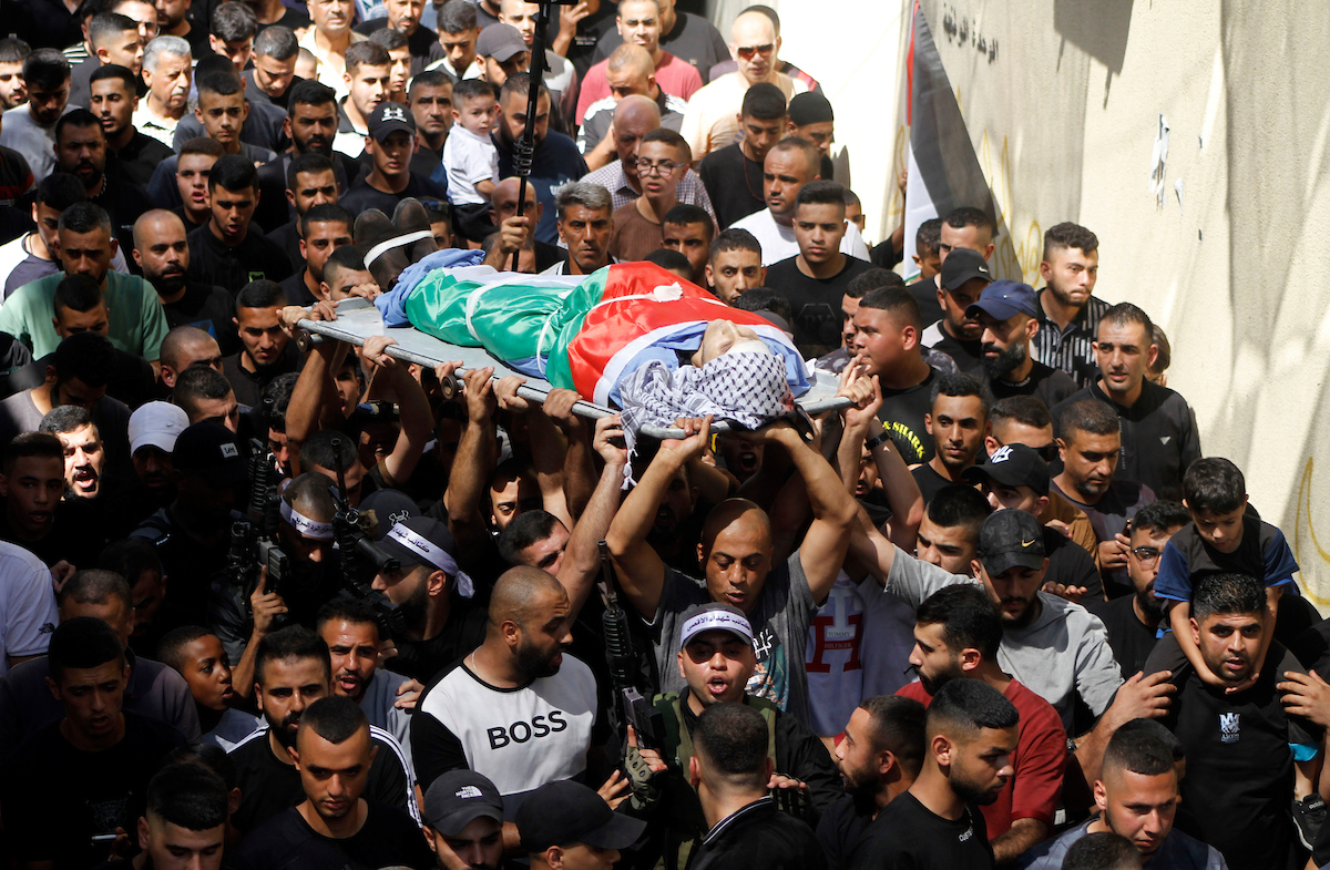 Palestinian mourners on September 5 2023 carry the body of 21-year-old Palestinian Ayed Samih Khaled who was shot dead by Israeli forces during a raid in the Nur Shams camp for Palestinian refugees near the town of Tulkarem in the north of the West Bank. Israeli forces shot dead at least 16 Palestinians in September 2023.