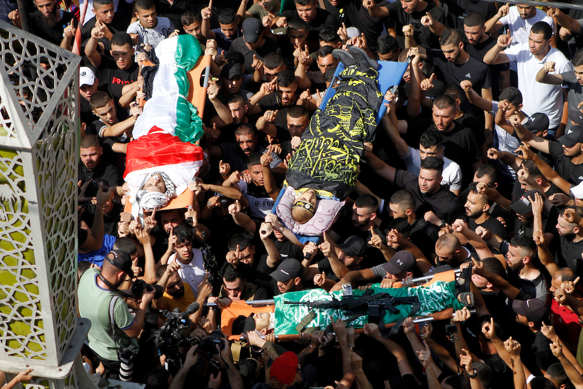 Mourners carry the bodies of three Palestinians killed in an Israeli raid on the Jenin camp for Palestinian refugees in the West Bank in the camp on September 20 2023. Israeli forces shot dead at least 16 Palestinians in September 2023.