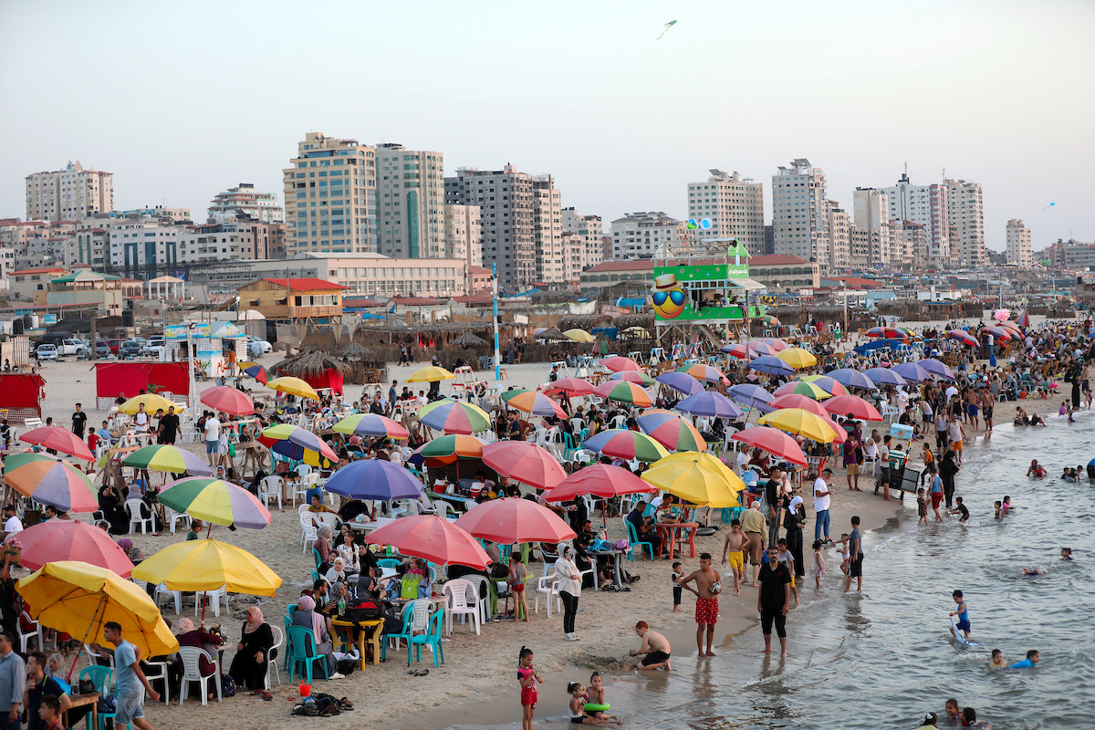 Palestinians on September 8 2023 enjoy their time on the beach of Gaza sea amidst soaring temperatures and power cuts. For Palestinians living on the crowded Gaza Strip a searing summer heat wave has been made worse by power cuts due to the ongoing Israeli blockade.